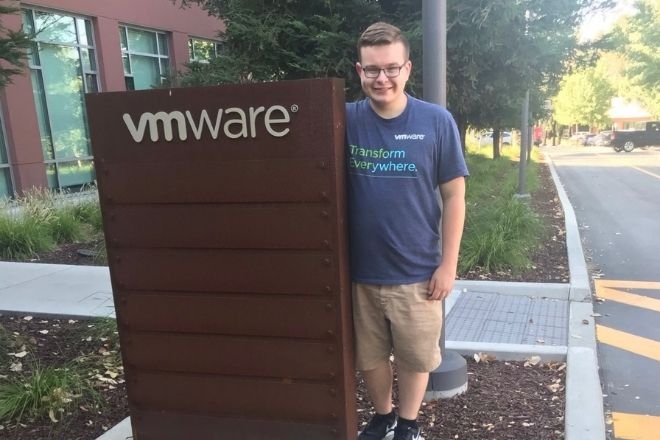 Charles Pearsall standing near the VMware sign