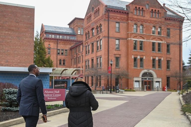 Dr. Kalid N. Mumin, Secretary of the Pennsylvania Department of Education, walks the Commonwealth University-Mansfield campus with North Hall in the background