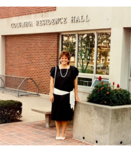 Pam Hallstead stands in front of Columbia Hall after graduation in 1984