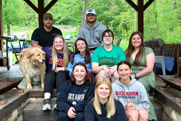 M.S. Athletic Training students sitting at a camp site