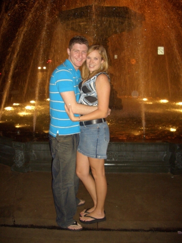 David Schur '04 and his wife in front of the fountain in downtown Bloomsburg