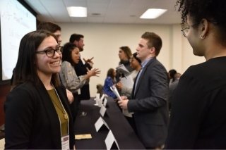 BU student speaks with an alum after an alumni panel