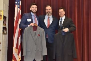 Jeremy Zezza '18 stands with Coach Mike Collins and fellow alum, Jason Vavra with donated men's suits.