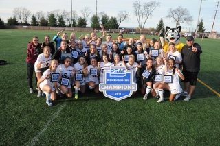 Women's Soccer poses with the PSAC championship plaque