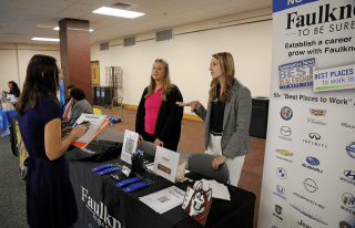 Kaeli Quick and another Faulkner recruiter speaks to a student at a recent career fair at Bloomsburg