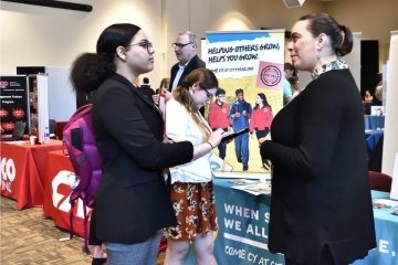 A City Year employee speaks with a BU student at the last Career Expo