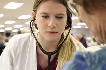 Student Nurse Take Blood Pressure in Community