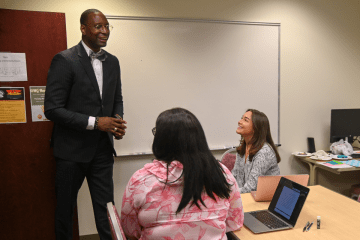Dr. Kalid N. Mumin, Secretary of the Pennsylvania Department of Education, visits with student interns in the TRiO office Commonwealth University-Mansfield, formerly Mansfield University