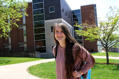 Emily Hackenberg poses in front of Hartline Science Center