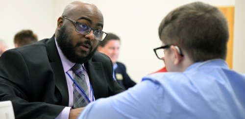 Alumnus conducting a mock interview with a student at Professional U's Career Boot Camp