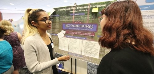 Student discusses her research at the annual SVURS event