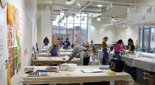 Art majors work on their projects in the paint studio of the Arts and Administration Building