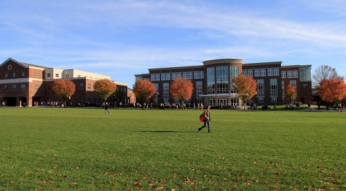 Students walk to class in front of Sutliff Hall in the fall