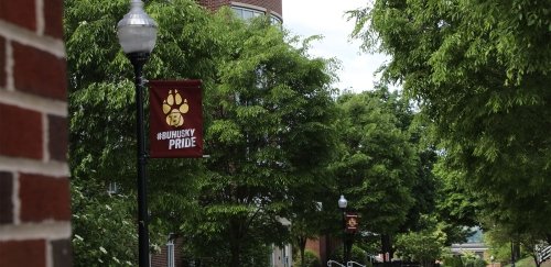 A Husky Pride banner on a lamppost on BU's beautiful campus.