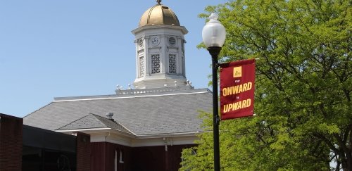 Our Onward is Upward lamppost banner near BU's iconic Carver Hall.