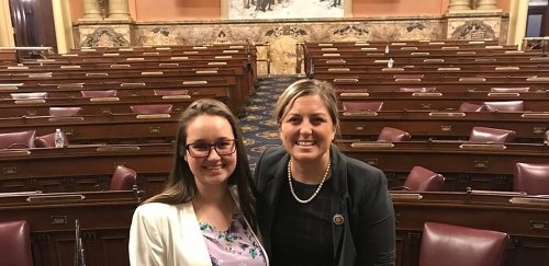 Political science smiles in the lobby chamber of her internship in Harrisburg