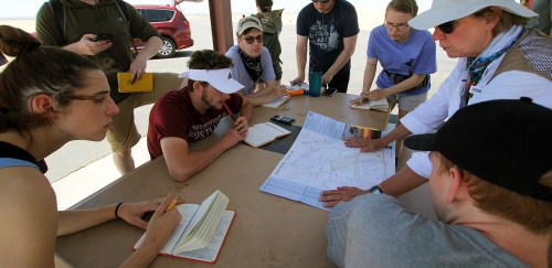 EGGS students map out their travels for the day during their field school in the desert