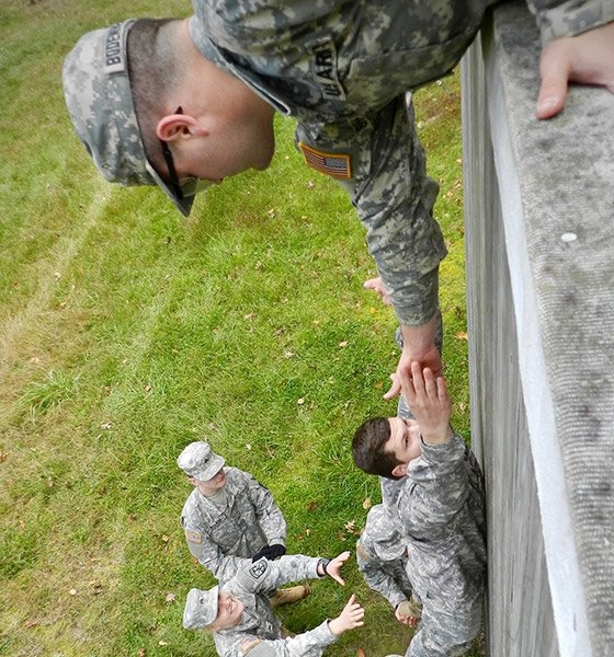 ROTC student climbing a wall