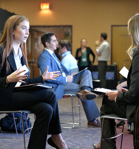 Business major interviews with an alumnus during ZIPD Business Conference