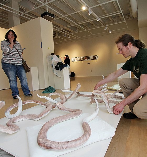 Art major sets up his sculpture display for the Senior Exit Art Show 