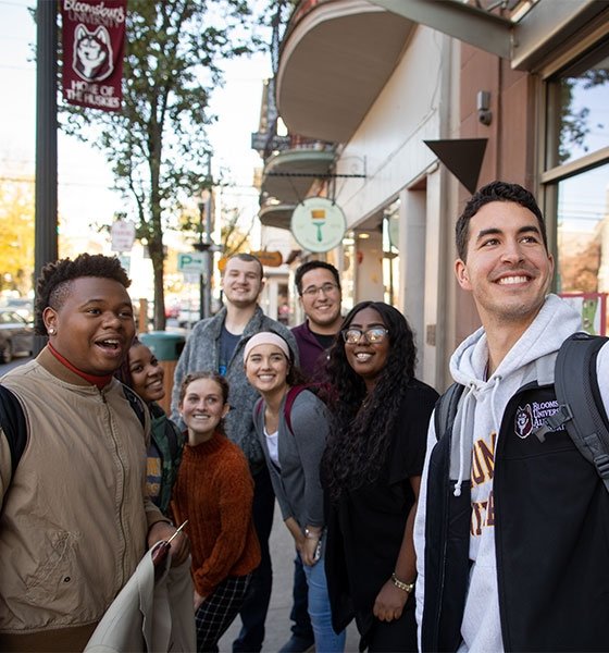 BU students stop to pose for a selfie while walking in downtown Bloomsburg.