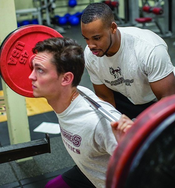 Exercise science students conduct strength training in Centennial Hall's weight room