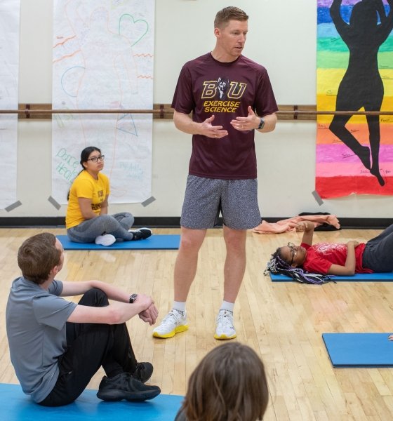 Luke Haile, PhD, teaching students in an Exercise Science class in the Centennial Hall gym.