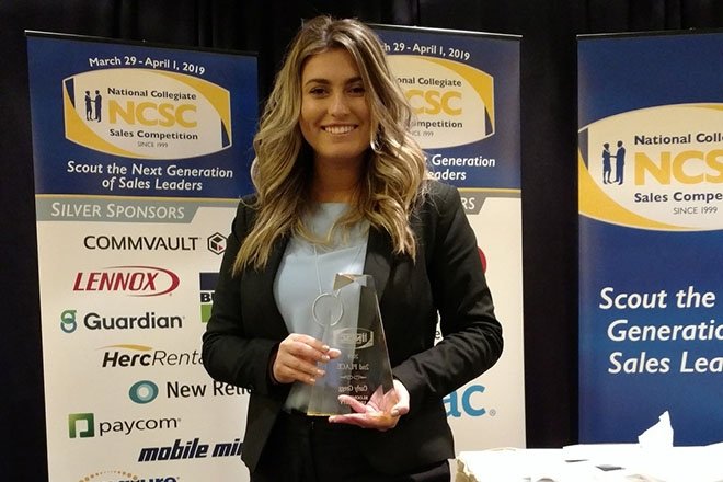 Professional sales major shows off her award from the annual NCSC event in Florida