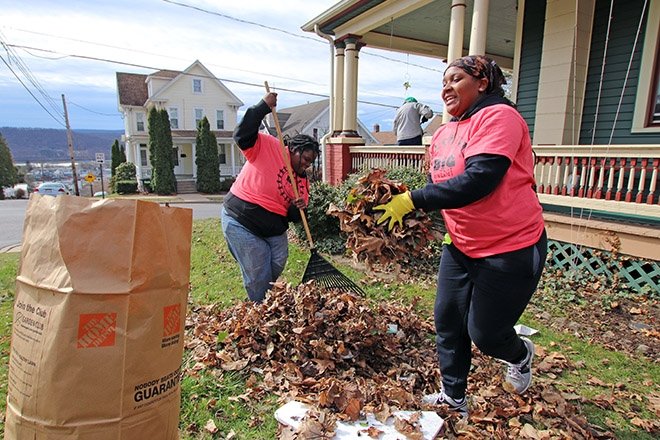Students help rake the yard of a neighbor during the annual The Big Event