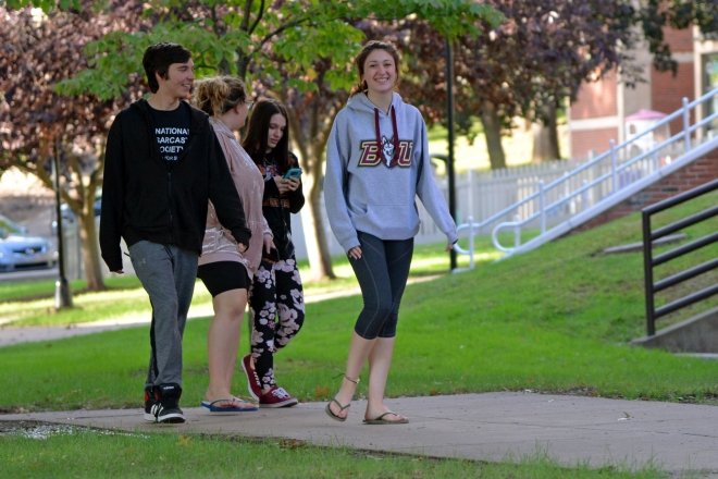 Students walk on campus in the fall.
