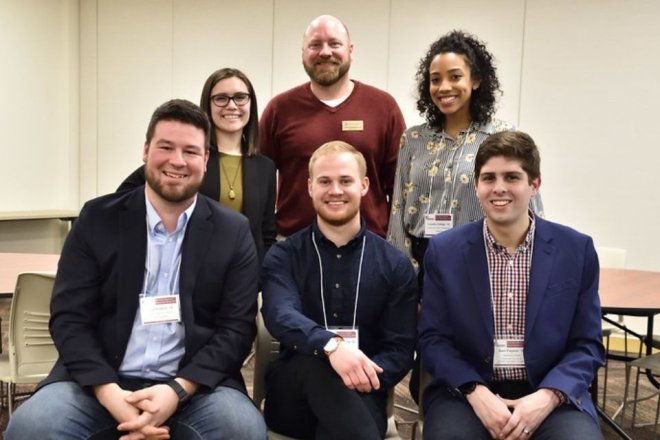 Cole Kresch (far left) and five other alumni panelists pose for a group photo during the Career Intensive Boot Camp.